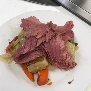 a plate of corned beef and carrots