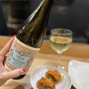 a person holding a bottle of wine