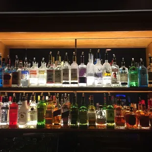 a shelf full of liquor bottles
