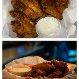 a basket of chicken wings and a basket of dips