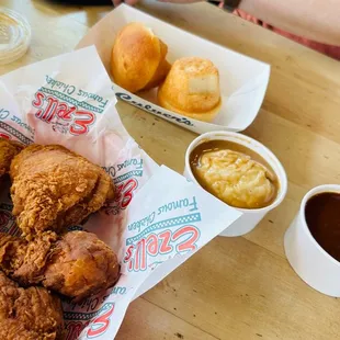 4 pieces dark meat chickens with mashed potatoes and bake bean side dishes