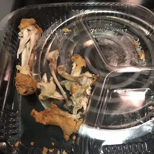 Leg on the left, wing lump bones on the right, hardly any meat.