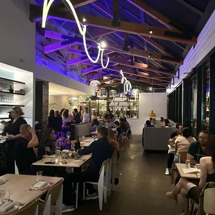 people sitting at tables in a restaurant