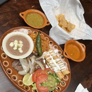 Tapiquena 6oz skirt steak flautas rice,beans and garnish