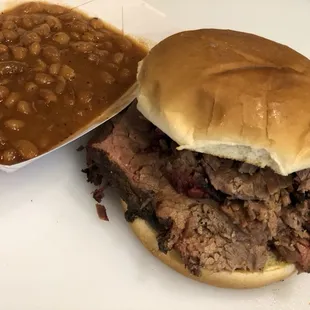 Sliced Brisket Sandwich and BBQ Beans