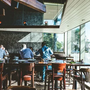 a group of people sitting at a table in a restaurant