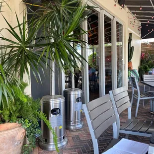 a patio area with tables and chairs