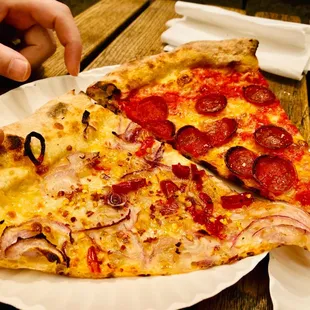 two slices of pizza on a paper plate