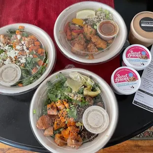 three bowls of food on a table