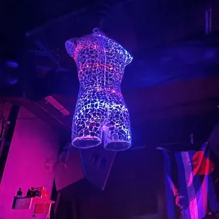 a mannequin suspended from the ceiling