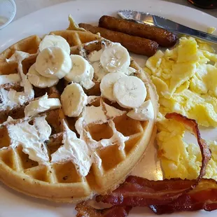 Hungry man breakfast with banana nut Belgian waffle.