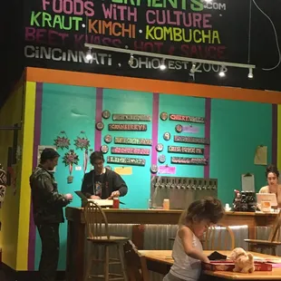 a little girl sitting at a table