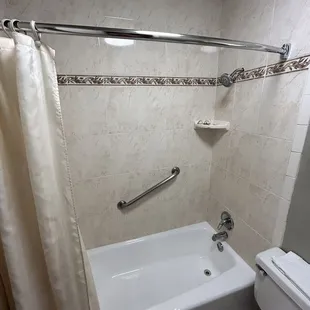Interior: bowed shower curtain road causes less water spillage onto the floor