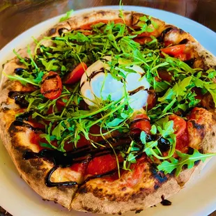 Bufalina - S.M. D.O.P. Tomato sauce, imported bufalina, orégano, garlic, local tomatoes, arugula, reduced balsamic, evoo