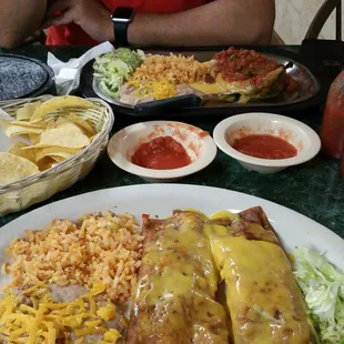 2 beef enchiladas with rice,beans, lettuce on side. Chile rennos with rice, beans, a dollop of avocado, lettuce and tortillas.