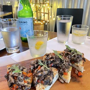 a pizza and a glass of water