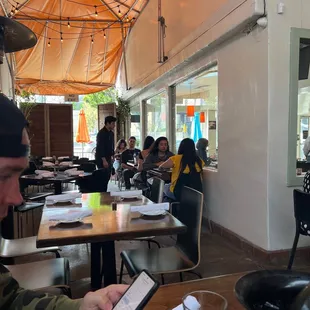 a man sitting at a table in a restaurant