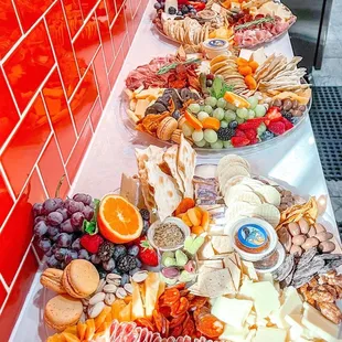 a variety of cheeses, crackers, and fruit