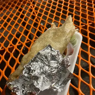 a hot dog wrapped in foil