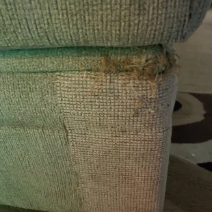 this is the over sized ottoman other side of sectional . tried covering it up w/ patch work but it looks unsightly. all 4 corners like this