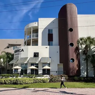 a man walking in front of a building