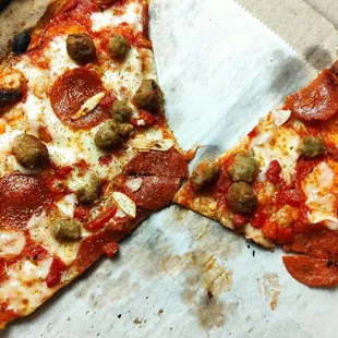 two slices of pizza in a box