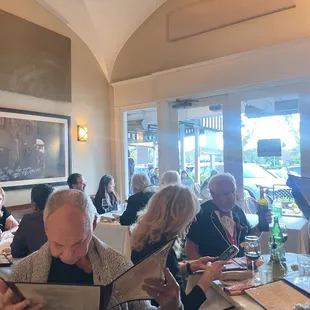 a group of people sitting at a restaurant