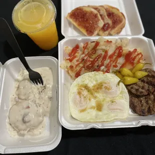 Biscuits and gravy, sausage patties, sourdough toast with jam, over medium eggs, some home style potatoes and some ice cold orange juice.