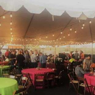 Tent with string lights, bright table linens and some table decor