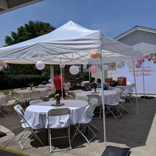 Their 10x20 ft white canopy, round tables and chairs. Just clean and ready to add your own touch.