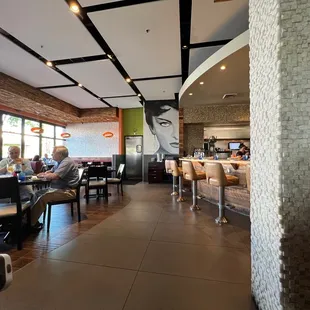 people sitting at tables in a restaurant