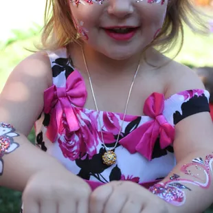 The happy results of her patience as she was painted to match her dress.