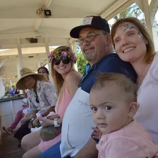 Happy faces for everyone at baby&apos;s 1st birthday party on a train.