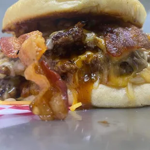 a hamburger with bacon and cheese