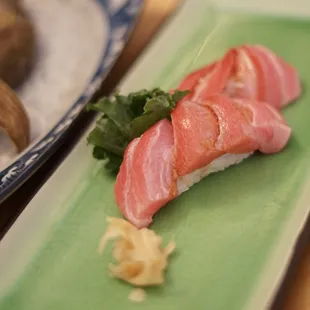 a plate of sushi on a green plate