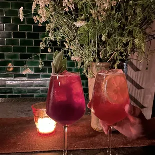 two glasses of wine and a candle