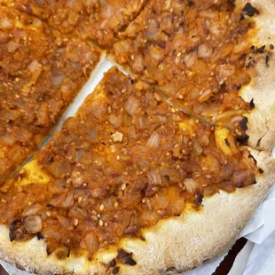 a pizza with a slice taken out of it