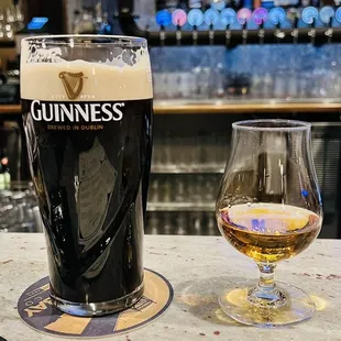 a glass of beer and a menu