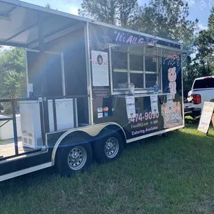 a food truck parked in the grass