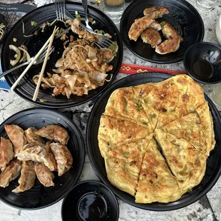 from to left- chicken chow fen, chicken potstickers, onion cake, and pork potstickers. (not in picture - dan dan noodles)