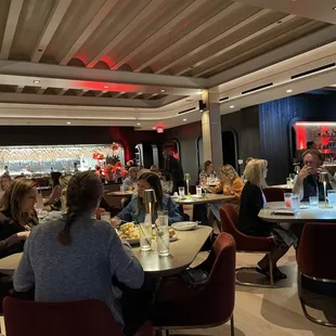people sitting at tables in a restaurant