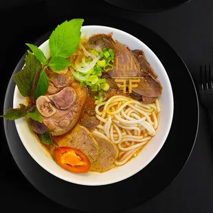 BUN BO HUE: Simmered beef shanks, pork hock and bones, the dish is greatly admired for its balance of spicy, salty and sweet with lemongrass