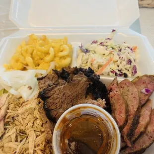 Three meat plate with sausage, brisket and chicken. Sides: cole slaw and mac and cheese.