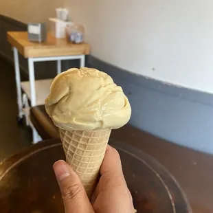 a hand holding an ice cream cone