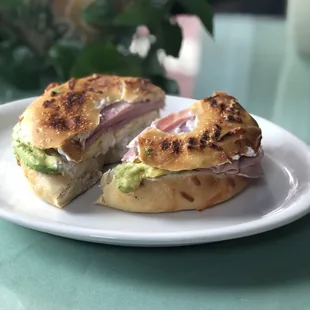 Cheesy garlic bagel with egg, ham, cream cheese and avocado!
