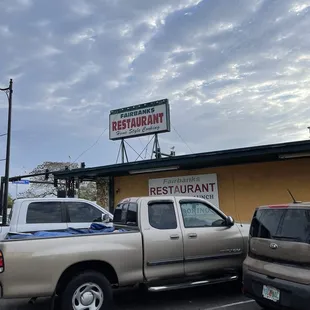 a truck parked in front of a restaurant