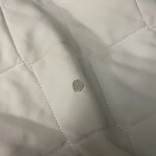 cigarette burn on unclean comforter
