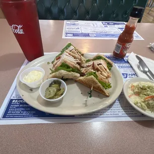 a plate of sandwiches and coleslaw