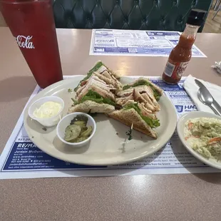 a plate of sandwiches and coleslaw
