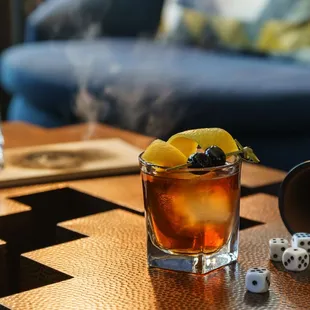 Smoked Maple Old Fashioned - Woodford Reserve, maple syrup, orange slide and cherry.